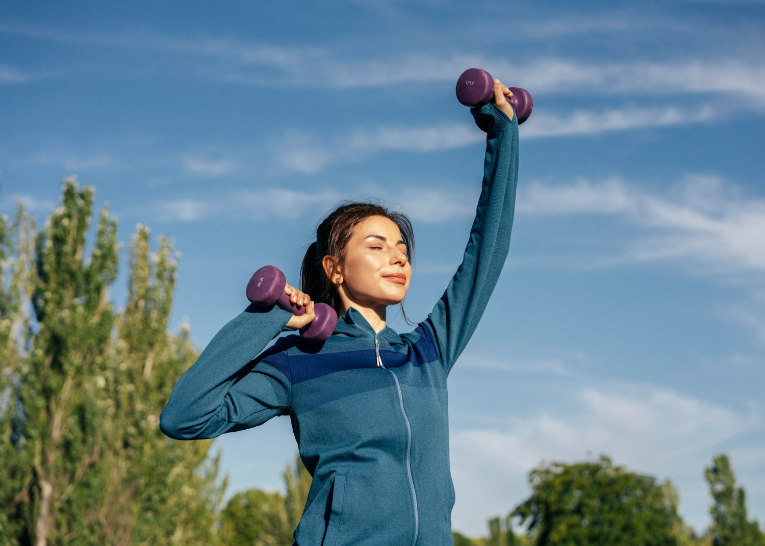 Woman doing a morning workout outdoors, stretching and exercising under soft sunlight, symbolizing a healthy start to the day and commitment to long-term wellness.